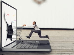 Businessman Pushes Shopping Cart Keyboard Laptop