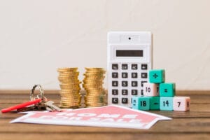Close Up Home Sale Icon With Key Stacked Coins Calculator Math Blocks