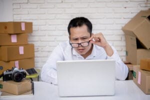 Young Man Working Marketing Online With Laptop Box Post